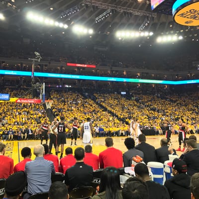 Basketball players compete on the court at Oracle Arena during an NBA