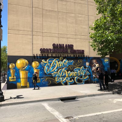 A large mural reading "Dubs Dynasty" decorates the exterior wall of the