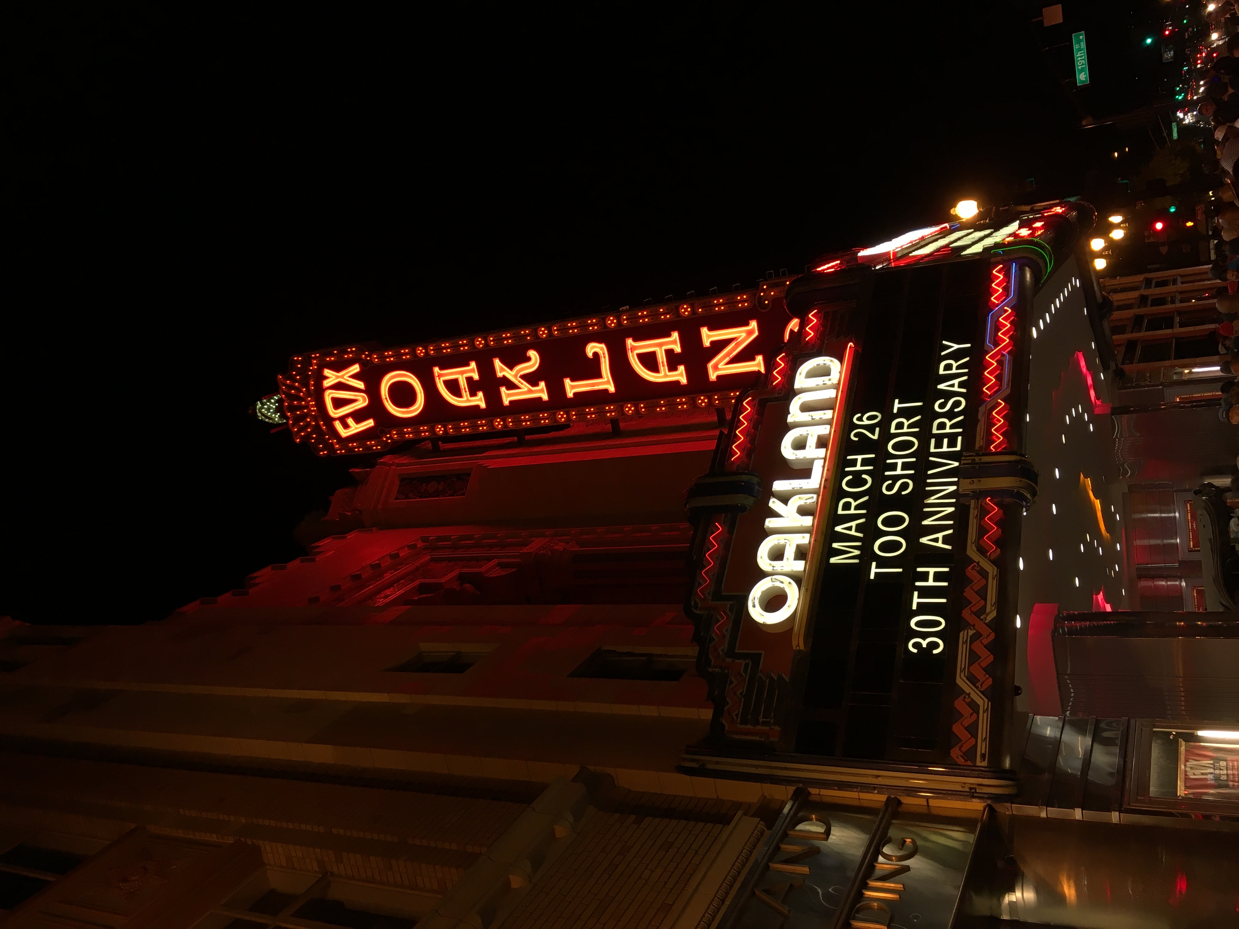 The iconic Fox Oakland Theater marquee glows with red neon lights against