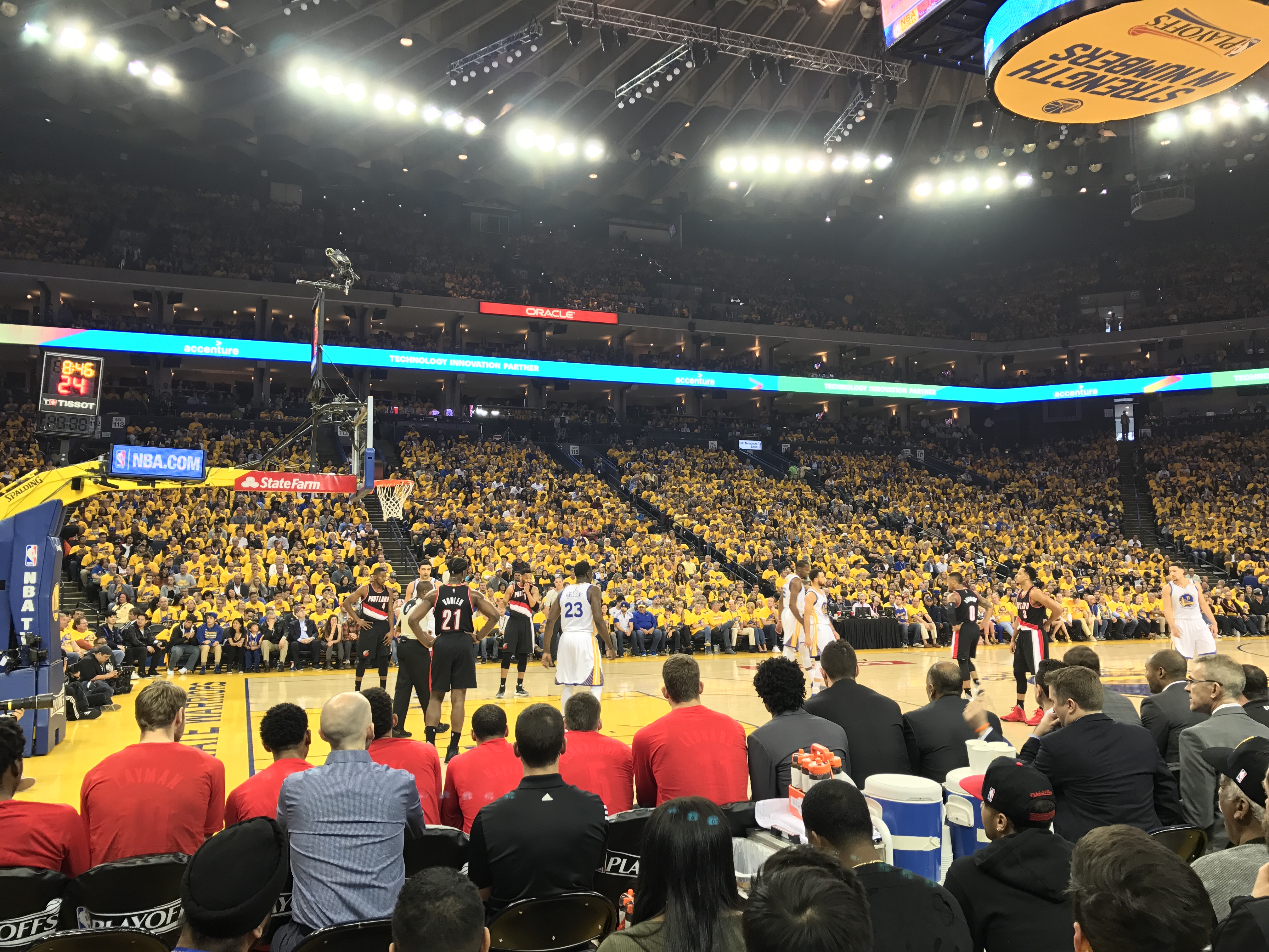Basketball players compete on the court at Oracle Arena during an NBA
